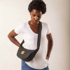 Black round mini vegan leather shoulder bag with Kenyan fabric lining, compact and stylish Ecodunia crossbody bag.