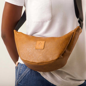 Brown vegan leather round mini shoulder bag with Kenyan fabric lining by Ecodunia, stylish crossbody purse with vibrant interior detail.