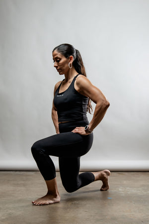 Hot Trend Vault SOHO women's black three-quarter length technical leggings laid flat, showcasing their sleek design and comfortable fit.