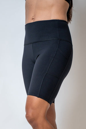 Black SOHO Women's Technical High Rise Shorts with 8-inch inseam, displayed on a model showcasing their fit and style.