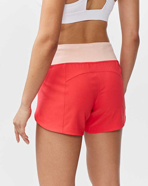 Hot Trend Vault Excel women's workout shorts in coral with extra coverage, shown from the back for active fitness and training.