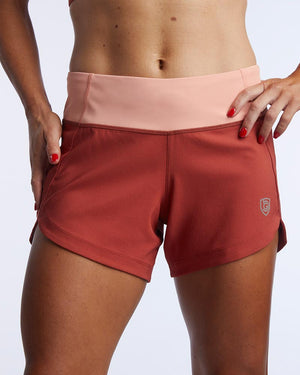 Excel Women's Workout Shorts by Hot Trend Vault in cinnabar and faded rose, showing front view with extra coverage for active sprints.