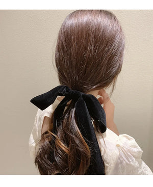 Velvet bow scrunchie hair tie by Hot Trend Vault, soft elastic hair accessory with a stylish bow for women and girls.