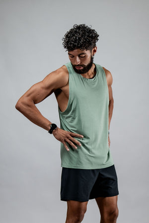 Men's olive green Terra Recovery Tank top by Hot Trend Vault, low light image showcasing the casual sleeveless design.