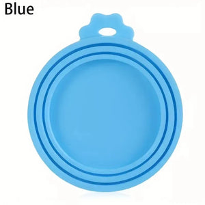 Reusable silicone pet can lid for dogs, BPA-free and durable, shown on a metal can in a practical kitchen setting.