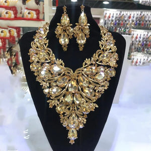 Hot Trend Vault rhinestone drop necklace and earrings set with exaggerated drag queen glam, featuring sparkling stones and bold style.