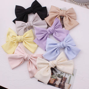 Elegant satin bow barrette hair clip by Hot Trend Vault with oversized knot design for women, stylish hair accessory.