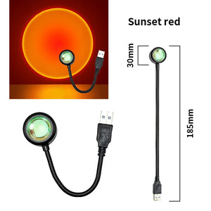 Hot Trend Vault sunset lamp projector displaying colorful rainbow night light for romantic ambiance in a bedroom setting.