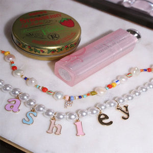 Colorful pearl letter necklace for women by Hot Trend Vault, featuring personalized stainless steel gold-tone jewelry with vibrant pearls.