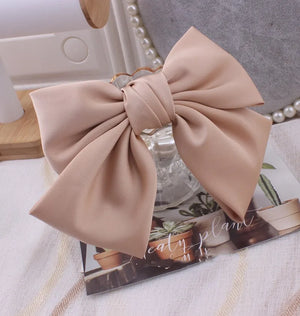 Elegant oversized satin bow knot hair clip by Hot Trend Vault, perfect for women’s stylish hair accessories and hair styling.