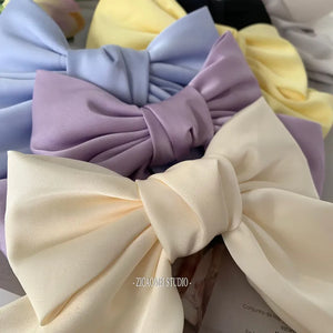Oversized satin bow knot barrette hair clip for women, elegant hair accessory with a shiny, smooth finish from Hot Trend Vault.