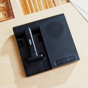 Hot Trend Vault DOSS wireless Bluetooth speaker with 15W charger, adjustable phone stand, and 8-hour playtime on a desk.