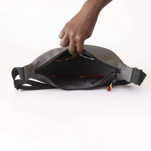 Gray round mini vegan leather shoulder bag with Kenyan fabric lining, stylish Ecodunia crossbody bag for everyday use.