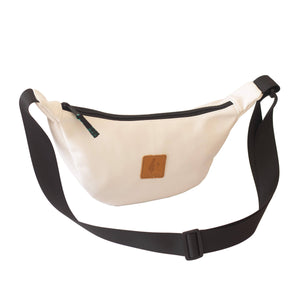 White round mini vegan leather shoulder bag by Ecodunia with colorful Kenyan fabric lining, stylish and compact accessory.