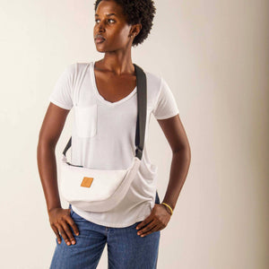 White round mini vegan leather shoulder bag by Ecodunia with Kenyan fabric lining, stylish crossbody bag for everyday use.