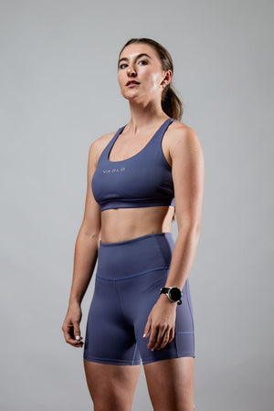 Women wearing Hot Trend Vault SOHO women's five-inch inseam fitness shorts in Lilac Mist, showcasing comfortable athletic wear.