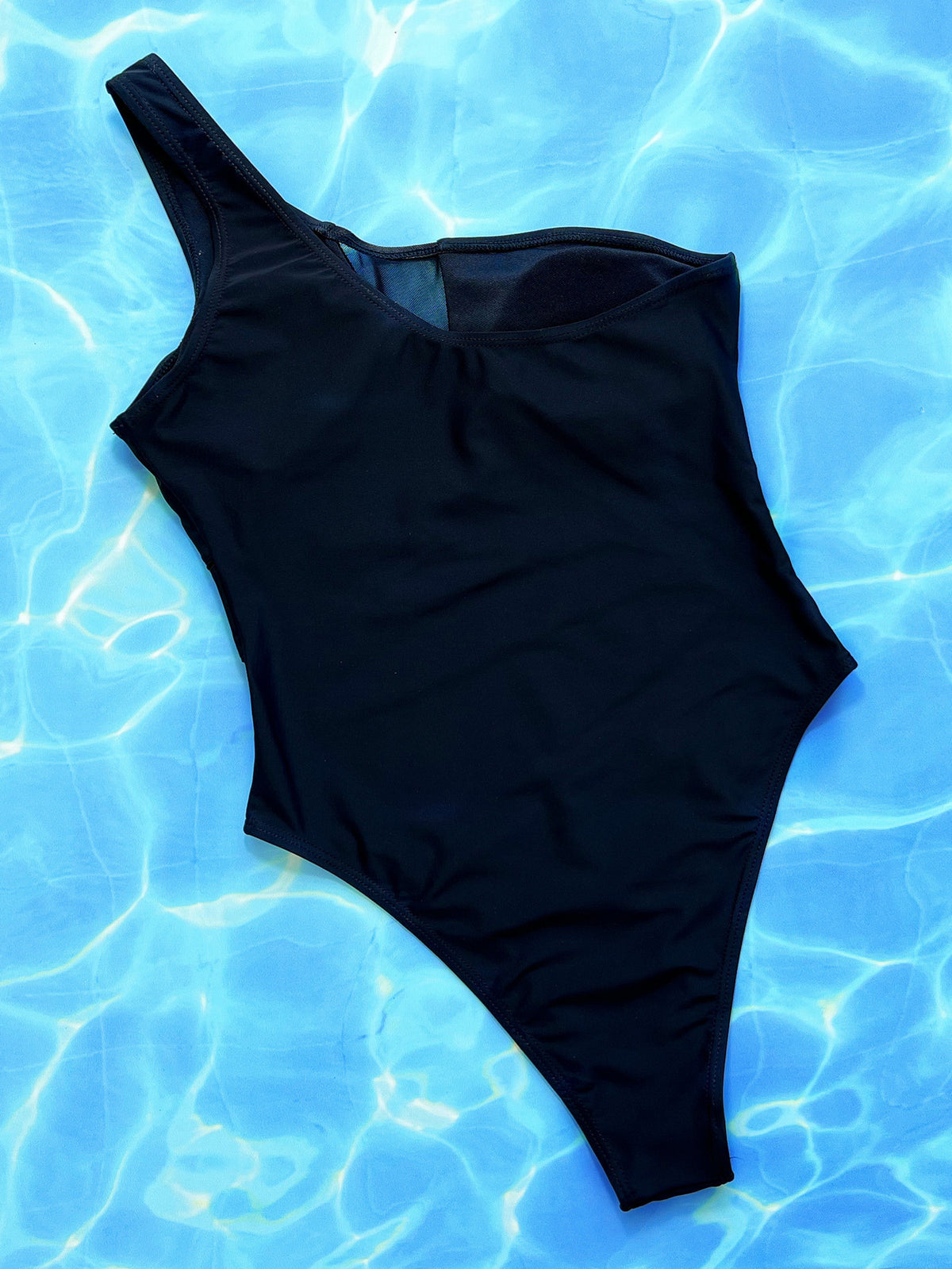 Women’s black one-piece swimsuit by Hot Trend Vault featuring a sleek, solid color design, perfect for beach or poolwear.