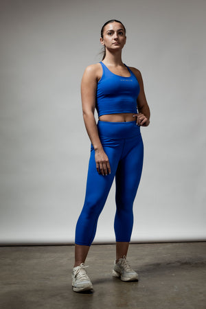 Women's Neo Blue Cross Back Crop Tank Top with Built-In Support by Hot Trend Vault, showcasing the stylish back design and fit.