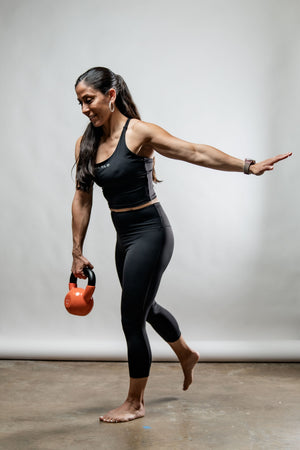 Black SOHO Women's three-quarter length technical leggings by Hot Trend Vault, showing a close-up of the fitted, stretchy fabric.