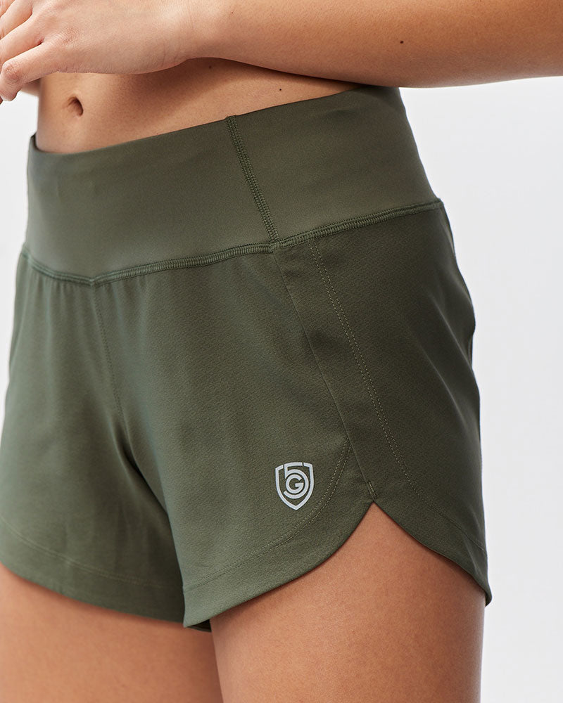 Dark moss green Excel women's workout shorts with extra coverage, designed for active training and comfortable movement.