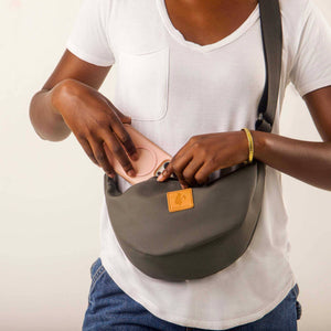 Gray round mini vegan leather shoulder bag with Kenyan fabric lining from Ecodunia, stylish and compact for everyday use.