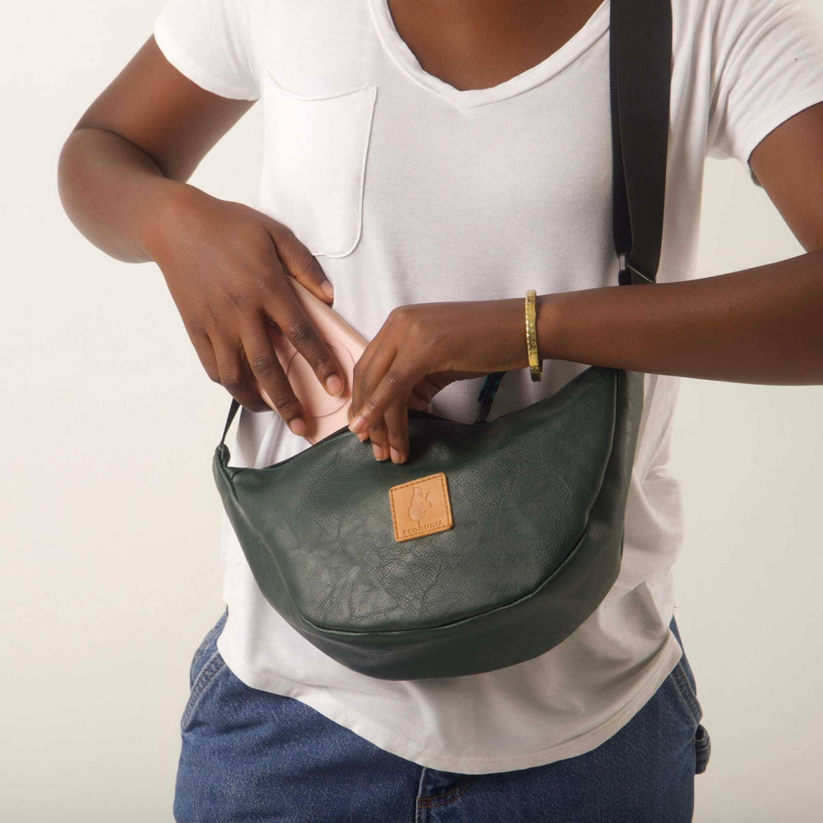 Green round vegan leather shoulder bag with Kenyan fabric lining, compact mini crossbody bag from Ecodunia.