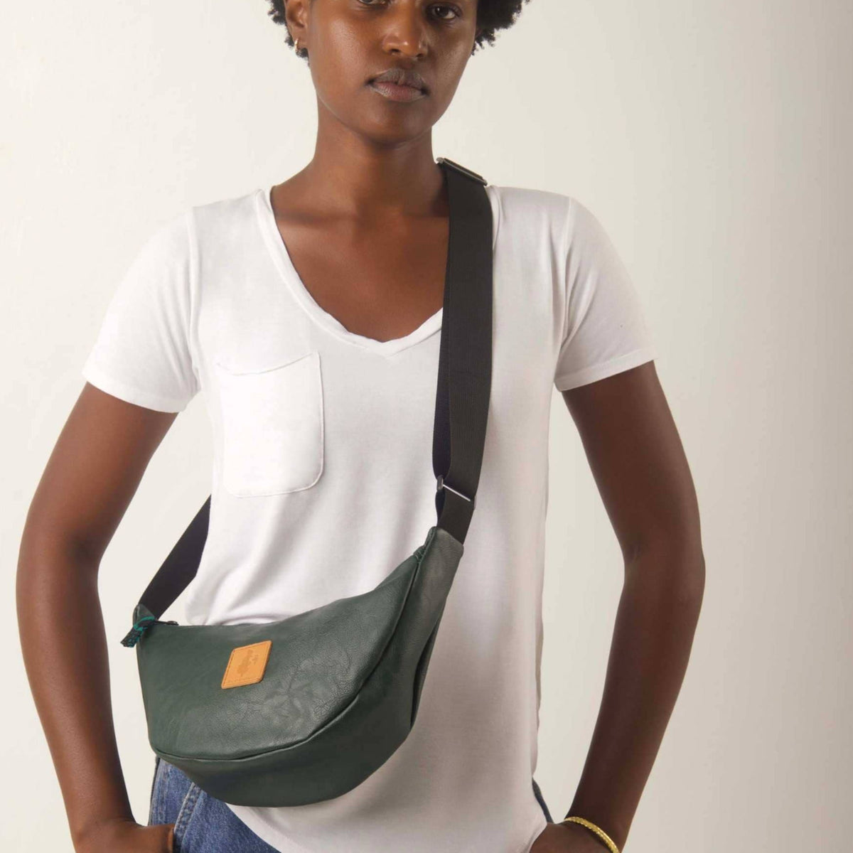 Green vegan leather round mini shoulder bag with Kenyan fabric lining from Ecodunia, stylish and compact crossbody bag.