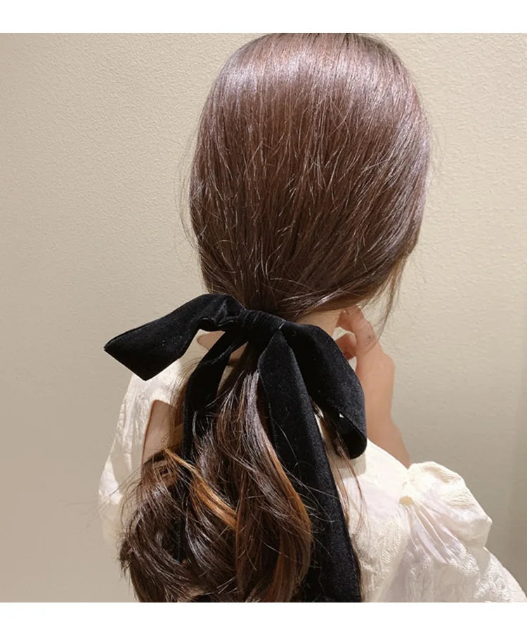 Velvet bow scrunchie hair tie by Hot Trend Vault, soft elastic hair accessory with a stylish bow for women and girls.