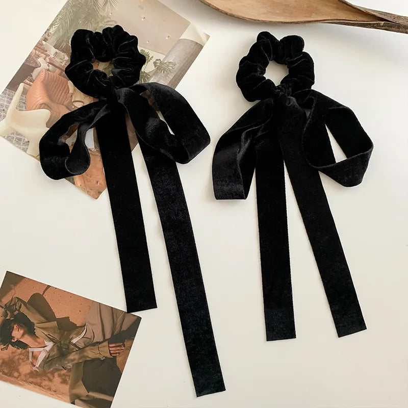 Black velvet bow scrunchie with vintage style, elastic hair tie for women and girls, featuring a classic ribbon design.