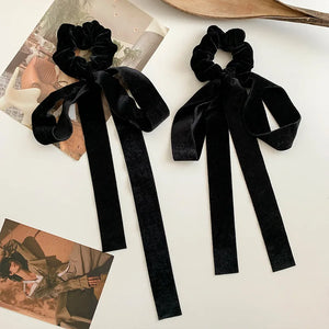 Black velvet bow scrunchie with vintage style, elastic hair tie for women and girls, featuring a classic ribbon design.
