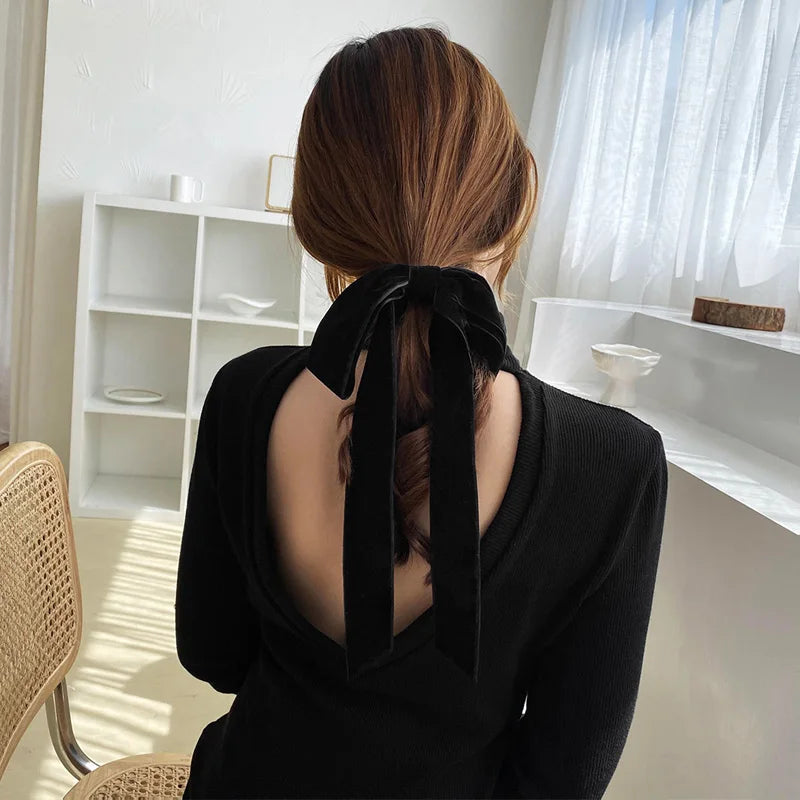 Velvet bow scrunchie hair tie by Hot Trend Vault, soft elastic hair accessory for women and girls, stylish and gentle on hair.
