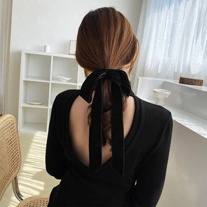 Black velvet bow scrunchie for women and girls, vintage style, elastic hair tie with a soft, luxurious ribbon appearance.
