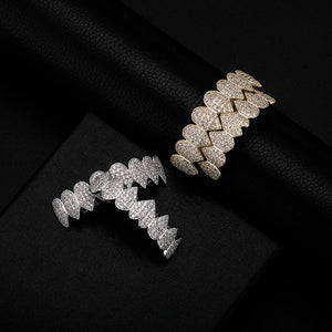 Iced Out CZ grillz teeth set in 14K gold plating for men and women, featuring top and bottom dental jewelry by Hot Trend Vault.