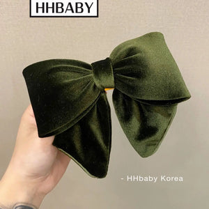 Elegant velvet hair clips with three-dimensional bowknot design by Hot Trend Vault, perfect for women and girls.