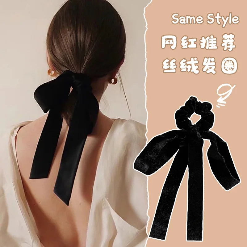 Velvet bow scrunchie hair tie by Hot Trend Vault featuring soft elastic fabric for women and girls, ideal for stylish hair accessories.