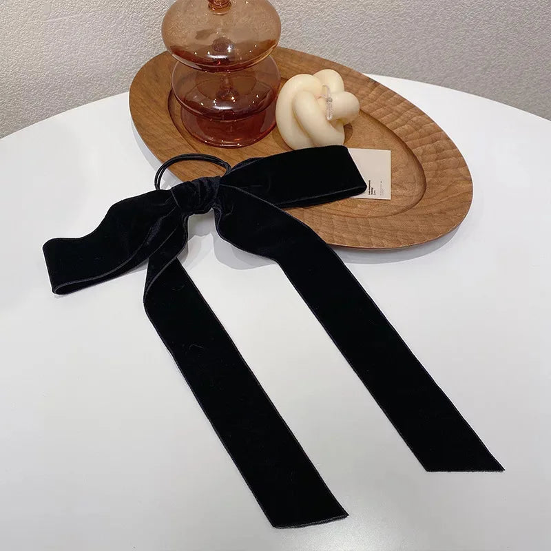 Black velvet bow scrunchie for women and girls, vintage hair ribbon and elastic hair tie, by Hot Trend Vault.