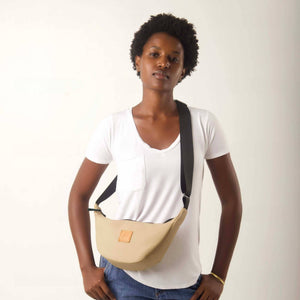 Round mini vegan leather shoulder bag by Ecodunia featuring Kenyan fabric lining and a stylish latte color.