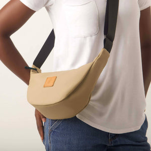 Round mini vegan leather shoulder bag with Kenyan fabric lining, by Ecodunia, featuring a stylish, compact design.