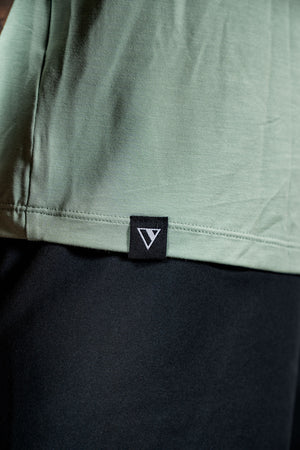 Men's Terra Recovery Polo by Hot Trend Vault in low light olive, showcasing a comfortable polo shirt with a classic fit and subtle branding.