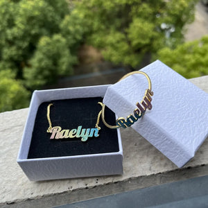 Colorful stainless steel gold nameplate bangles with custom kids' name necklace set, featuring vibrant designs and glittering accents.
