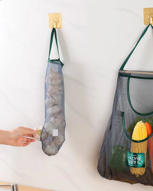 Reusable mesh storage bags hanging in a kitchen, ideal for storing vegetables, by Hot Trend Vault.