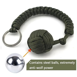 Outdoor self-defense umbrella rope kit with monkey fist steel ball and paracord key chain, designed for outdoor enthusiasts.