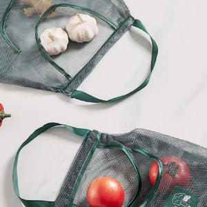 Reusable mesh storage bags for kitchen vegetables, hanging by Hot Trend Vault, keeps produce fresh and organized.