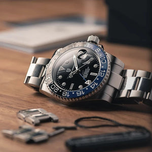 Luxury PAGANI DESIGN GMT men's watch with sapphire crystal, automatic movement, 40mm case, black dial, and stainless steel bracelet.