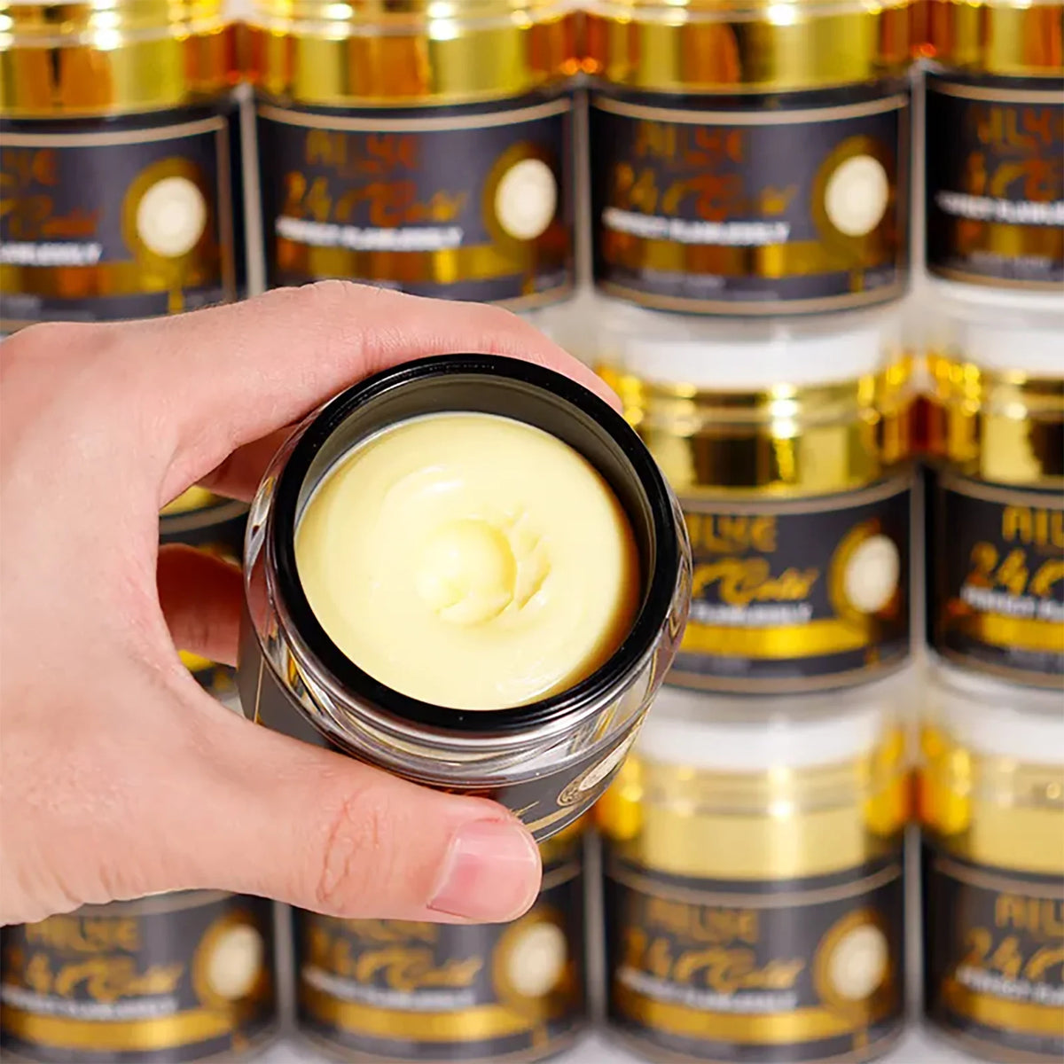 Close-up of AILKE 24K Gold Collagen Whitening cream jar from Hot Trend Vault with gold accents and product label.