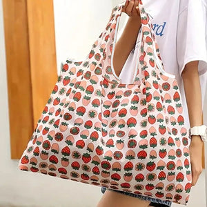Reusable folding shopping bag with cartoon lemon and strawberry print by Hot Trend Vault, eco-friendly portable tote for shoppers.