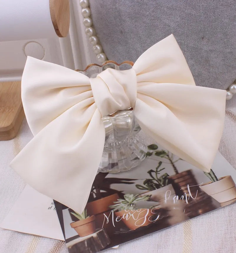 Hot Trend Vault oversized satin bow knot hair clip for women, elegant barrette accessory with a stylish, glossy finish.
