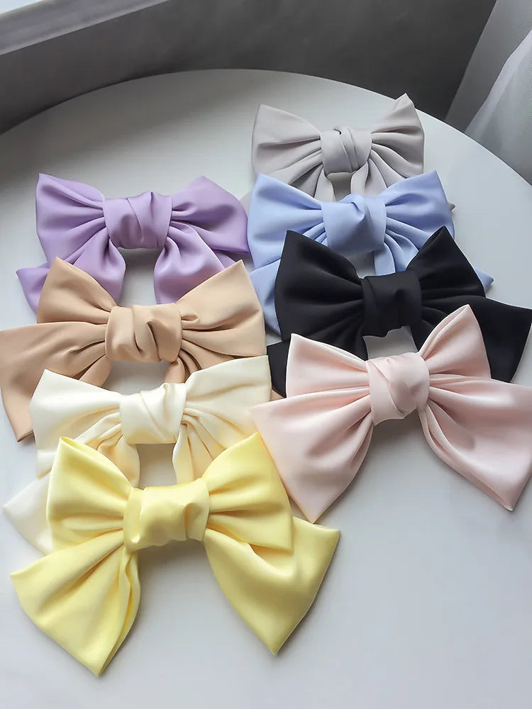 Hot Trend Vault MODENGCHONGER oversized satin bow knot hair clip for women, elegant hair accessory with a large bow design.