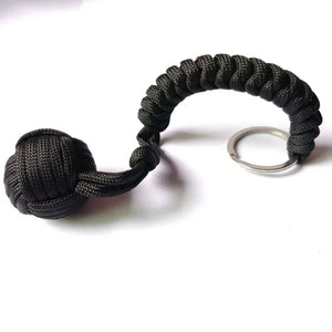 Self-defense umbrella rope kit with monkey fist steel ball and paracord key chain, designed for outdoor enthusiasts.