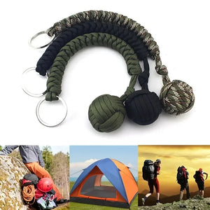 Outdoor self-defense umbrella rope kit with monkey fist steel ball and paracord key chain, ideal for outdoor enthusiasts.